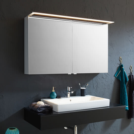 Customised mirror cabinets for your bathroom – example: Modern-Line mirror cabinet with glossy aluminium body, side surfaces in white glass and optionally available GLSU lighting